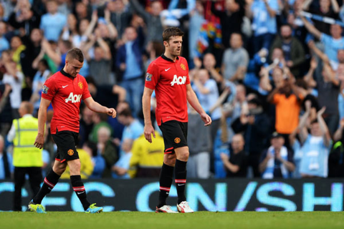 32-year-old Michael Carrick (right) struggled in the midfield against Yaya Toure. (Michael Regan/Getty Images)